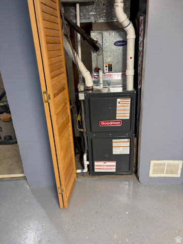 2313 150 East Bountiful, UT 84010 - Photo 36 of 39 Utility closet featuring a Goodman furnace and a Carrier air handler, with an adjacent louvered bifold door