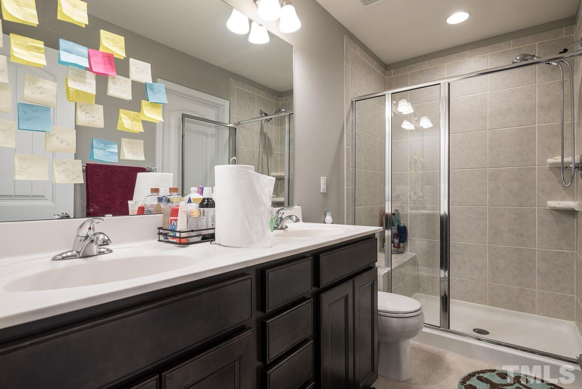 718 Maypearl Lane Raleigh, NC 27610 - Photo 14 of 23 a bathroom with a sink a toilet and shower