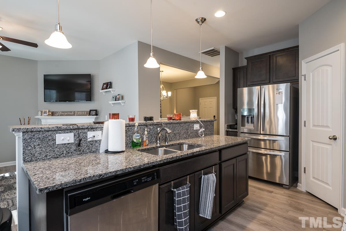 718 Maypearl Lane Raleigh, NC 27610 - Photo 3 of 23 a kitchen with stainless steel appliances a sink and a refrigerator