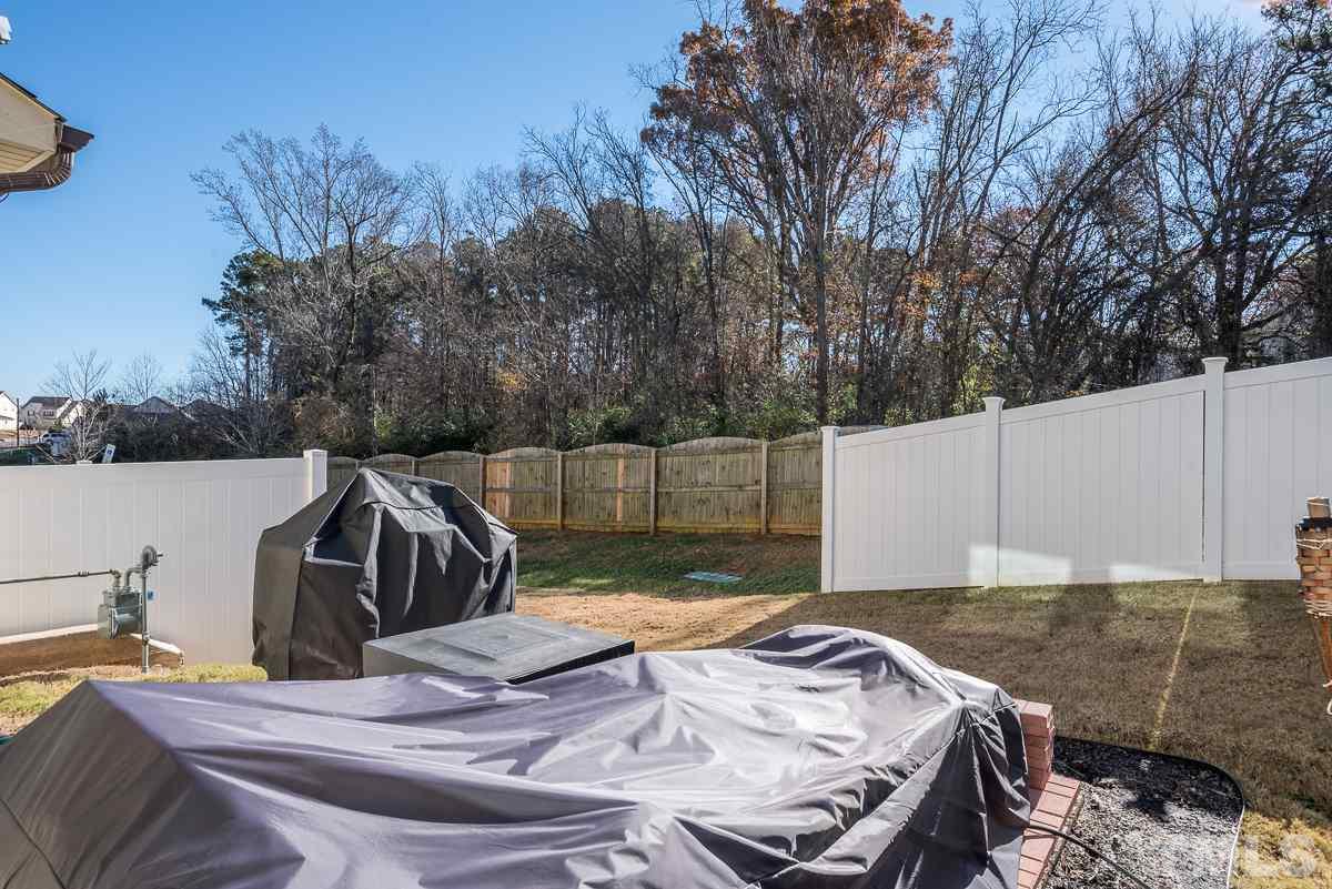 718 Maypearl Lane Raleigh, NC 27610 - Photo 22 of 23 a view of backyard of house with seating space