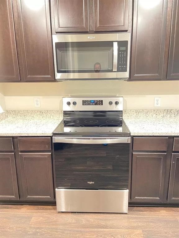 213 Allington Circle Jarrell, TX 76537 - Photo 15 of 16 a stove top oven sitting inside of a kitchen