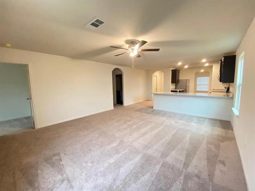 213 Allington Circle Jarrell, TX 76537 - Photo 3 of 16 a view of a kitchen with a sink and a chandelier fan