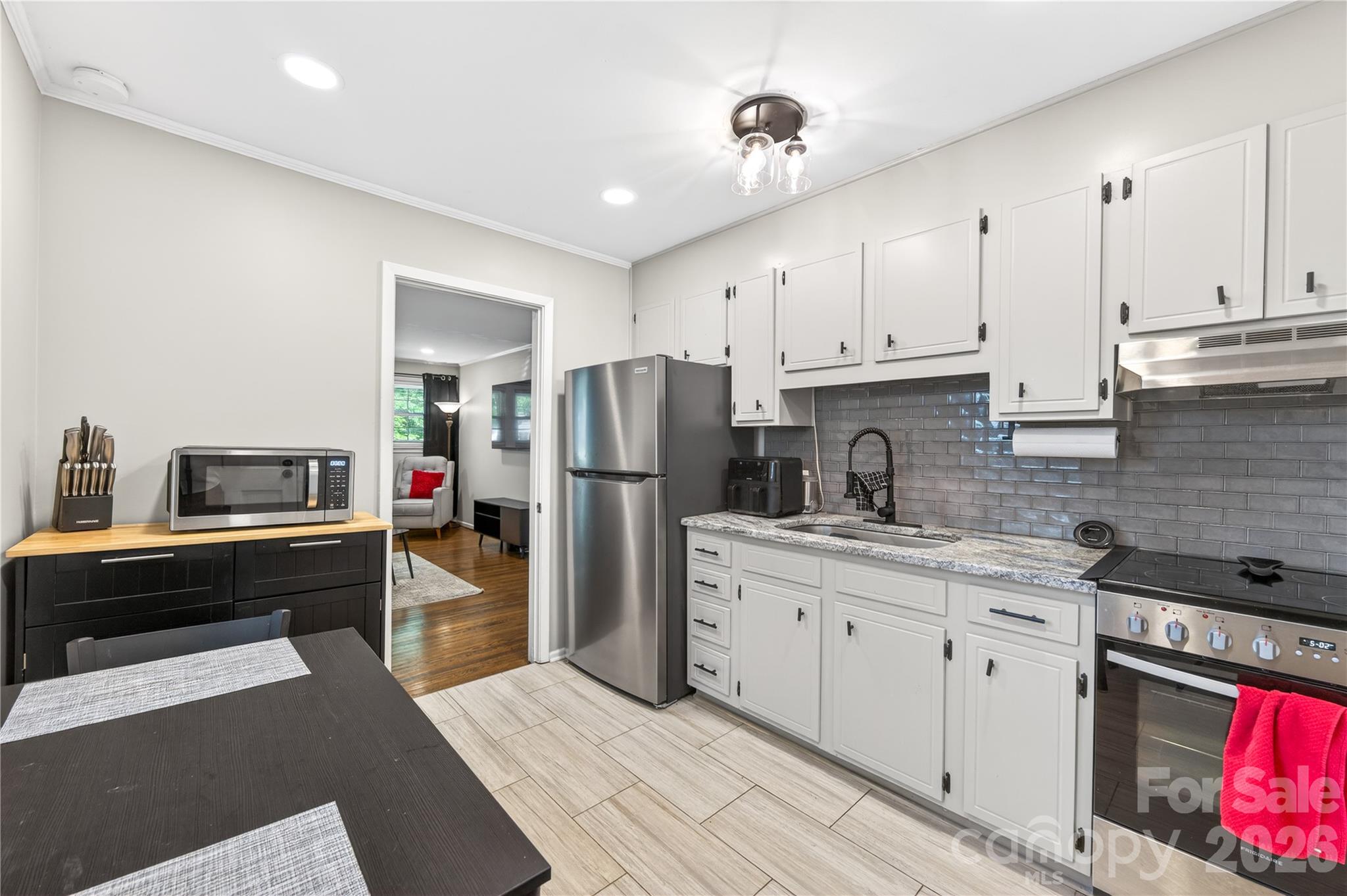 3241 Minnesota Road Charlotte, NC 28208 - Photo 10 of 18 a kitchen with stainless steel appliances granite countertop a refrigerator sink and stove