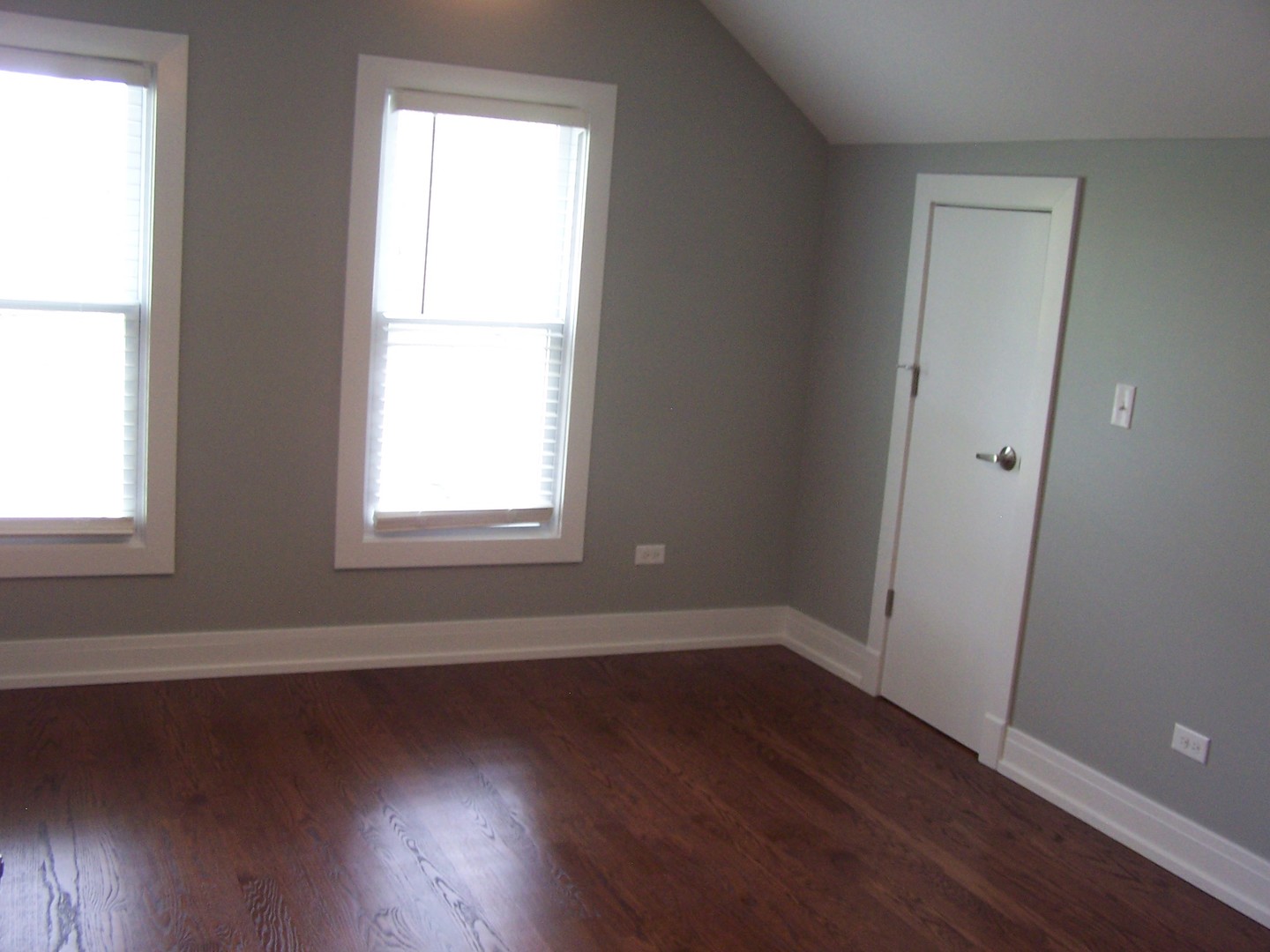 604 Clement Street Joliet, IL 60435 - Photo 15 of 17 an empty room with wooden floor and windows