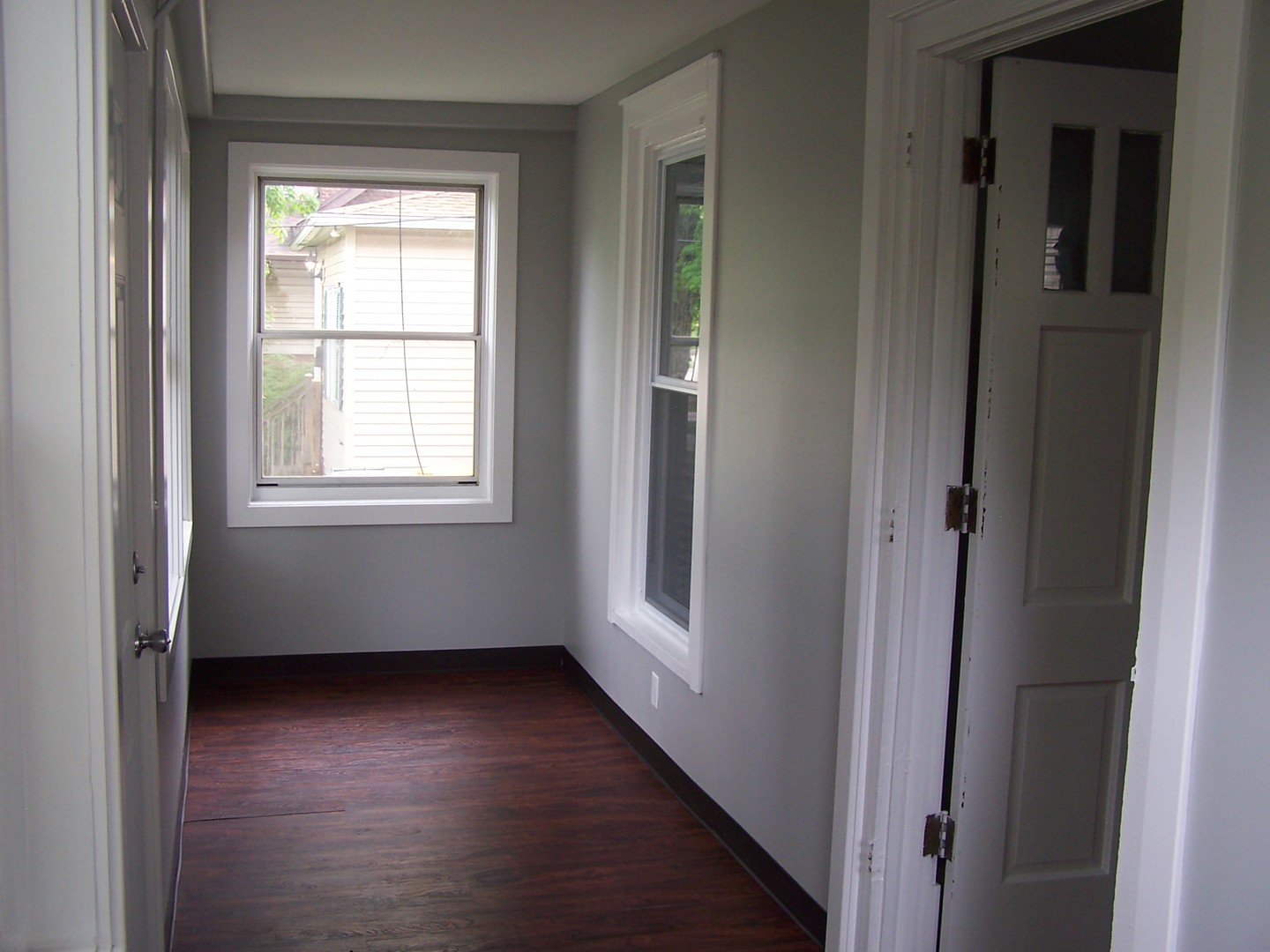 604 Clement Street Joliet, IL 60435 - Photo 8 of 17 an empty room with wooden floor and windows