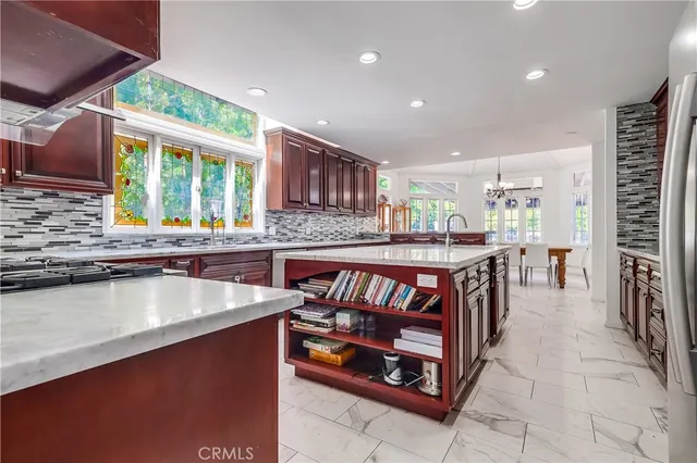 a kitchen with stainless steel appliances granite countertop sink stove and cabinets