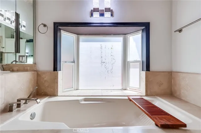 a bathroom with a bathtub and a window