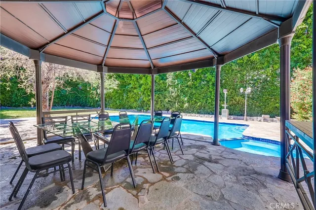 a view of chairs and table in the patio
