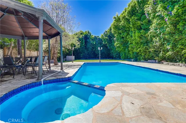 a view of a swimming pool with sitting area