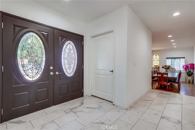 an entryway with a bench and a chair