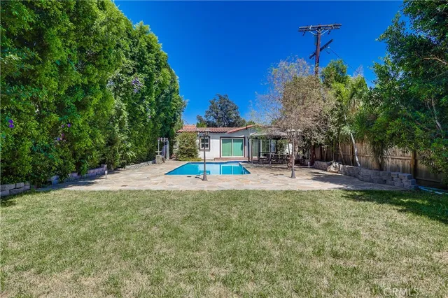 a view of house with outdoor space and swimming pool