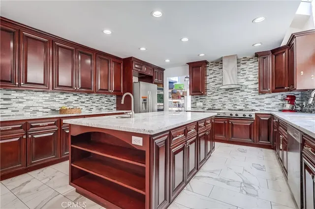 a kitchen with stainless steel appliances granite countertop a sink stove and cabinets