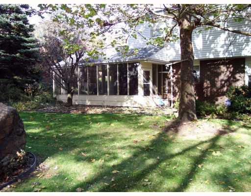 Exterior Back. Parklike backyard, enclosed porch off of the family room with the fireplace.