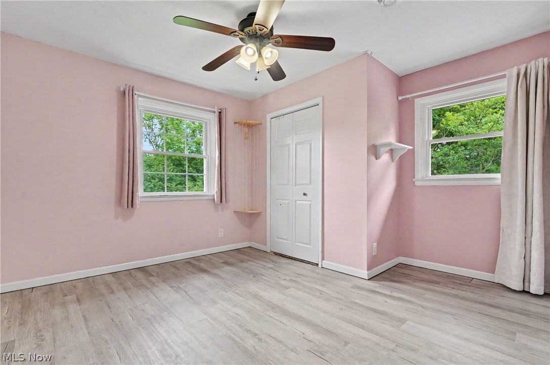 952 Ravenna Road Kent, OH 44240 - Photo 15 of 37 Bedroom with new LVT flooring, closet space and bright light.