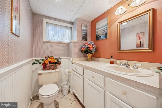 a bathroom with a toilet a sink and mirror