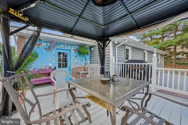 a view of outdoor dining space with a table and chairs
