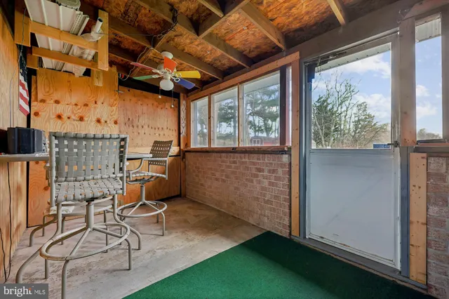a view of a room with chairs and windows