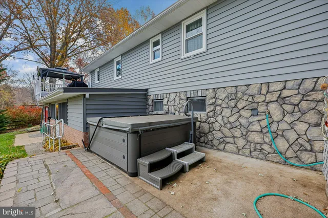a view of a patio with table and chairs with wooden fence and plants