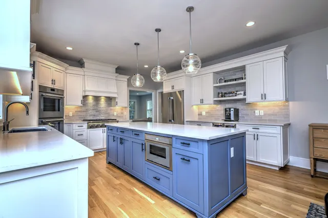 a kitchen with stainless steel appliances a sink stove and refrigerator