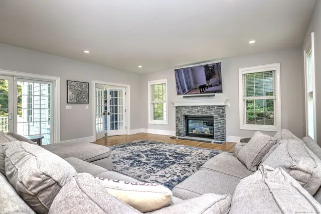 a living room with a large window and a fireplace