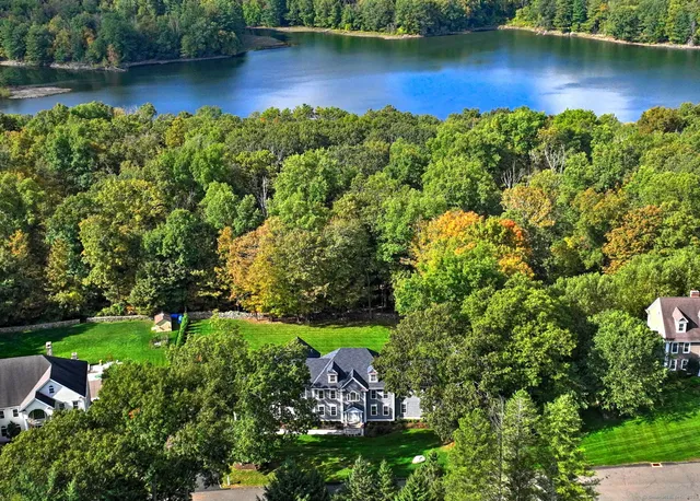 an aerial view of a house with outdoor space lake and lake view