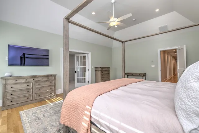 a spacious bedroom with a large bed and a dresser