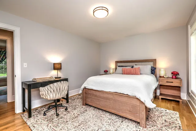a bedroom with a bed and a chair in it