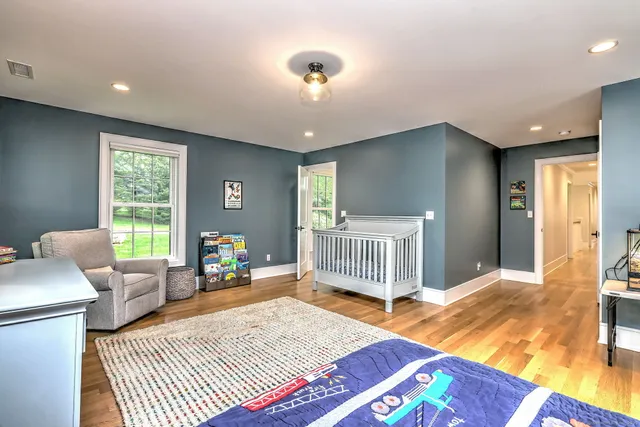 a bedroom with furniture and a rug