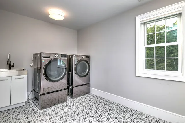a room with a washing machine and mirrors