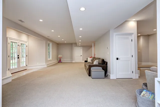 a hallway with a couch and a large window