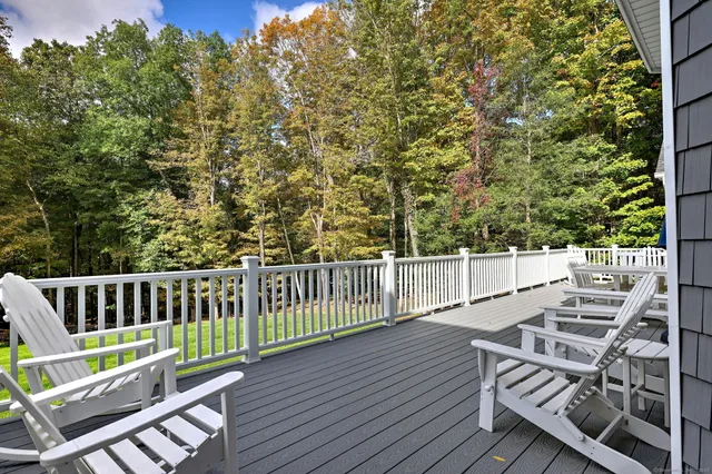 a view of balcony with wooden floor and outdoor seating