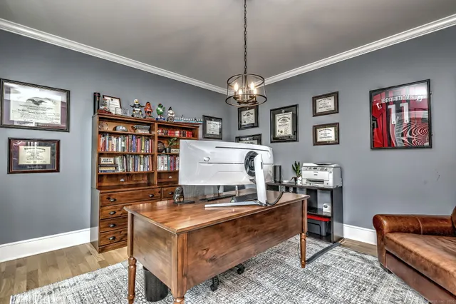 a living room with furniture and a chandelier