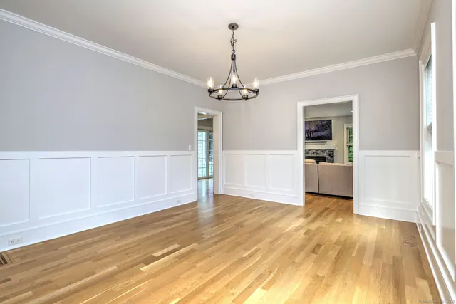 a view of a room with wooden floor and a ceiling fan