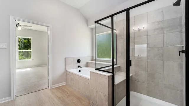 a bathroom with a bathtub and a shower