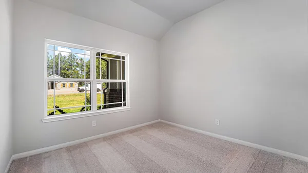 an empty room with window and mirror