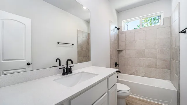 a bathroom with a sink a toilet and a bathtub