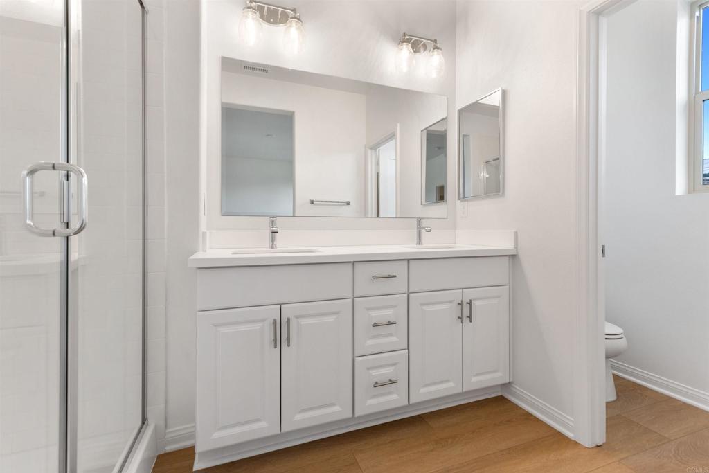1532 Redbud Way Oceanside, CA 92056 - Photo 19 of 40 a bathroom with a double vanity sink and mirror