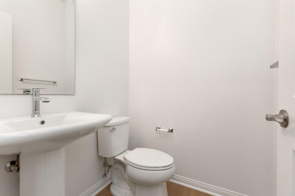 1532 Redbud Way Oceanside, CA 92056 - Photo 27 of 40 a bathroom with a sink toilet and a mirror