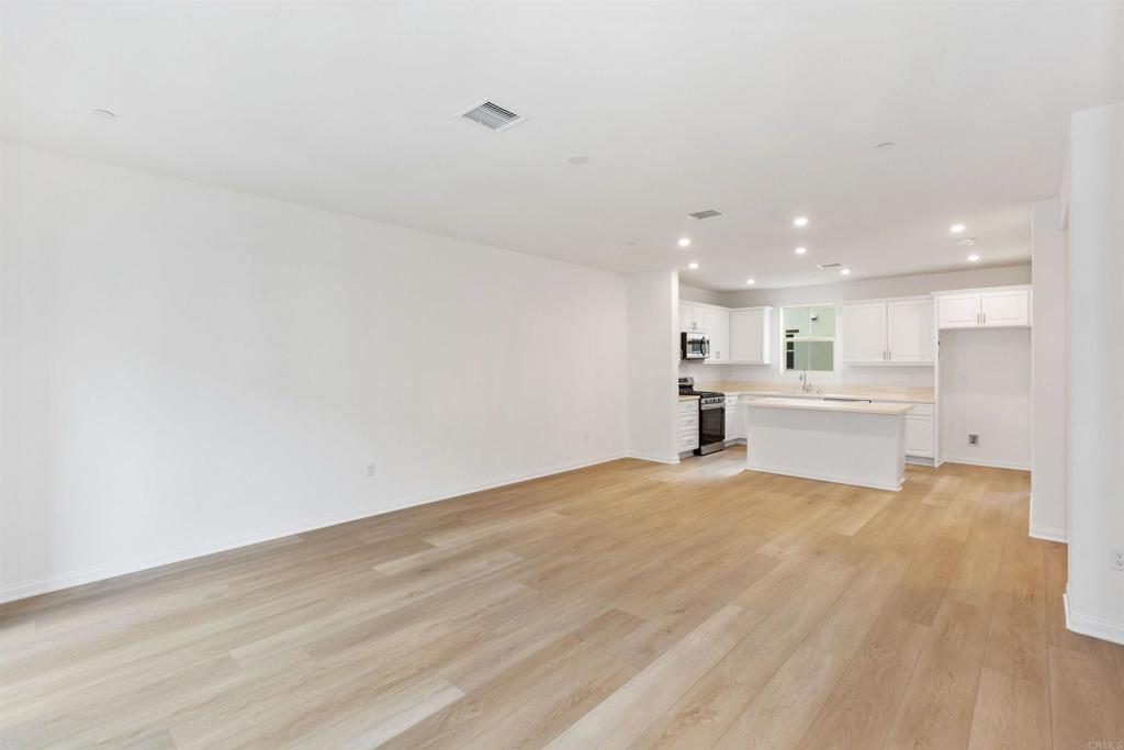 1532 Redbud Way Oceanside, CA 92056 - Photo 28 of 40 a view of an empty room with a kitchen