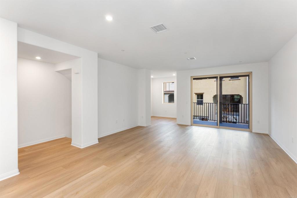 1532 Redbud Way Oceanside, CA 92056 - Photo 4 of 40 an empty room with wooden floor and a fireplace