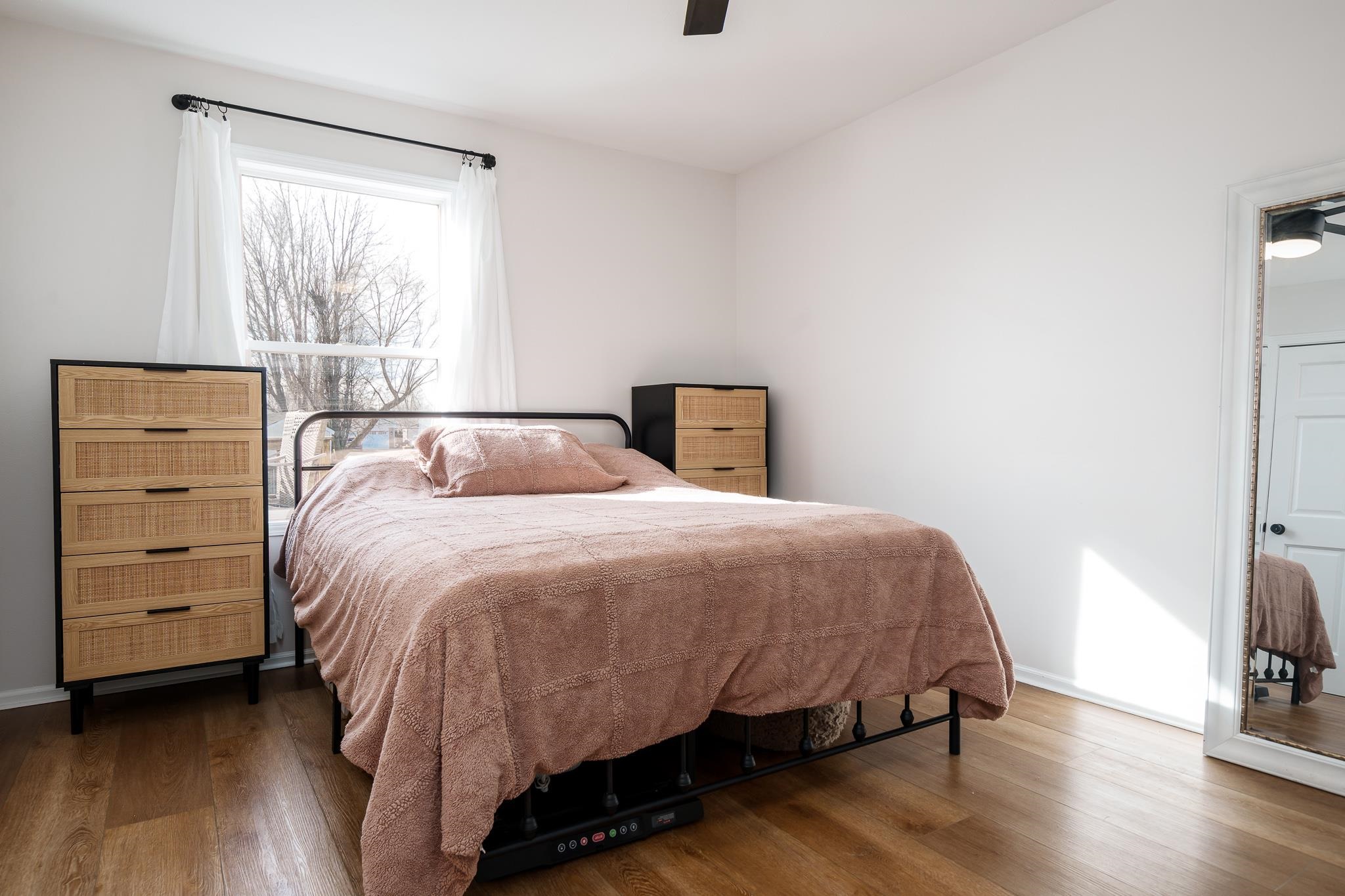 148 Prairie Moon Drive Davis Junction, IL 61020 - Photo 18 of 33 a bedroom with a bed a tv and wooden floor