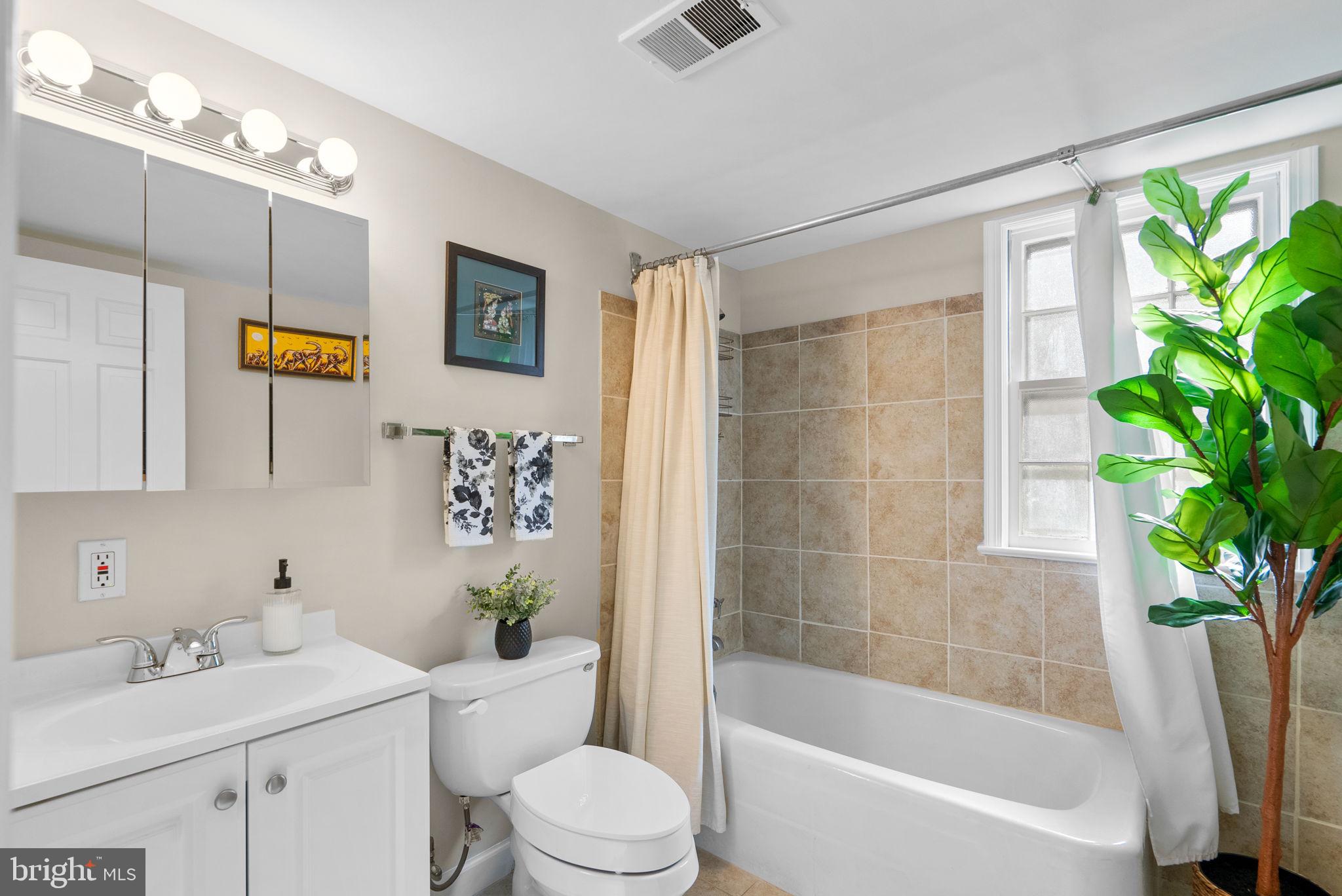 14530 Sturtevant Road Silver Spring, MD 20905 - Photo 17 of 47 a bath room with a toilet a sink and a bath tub