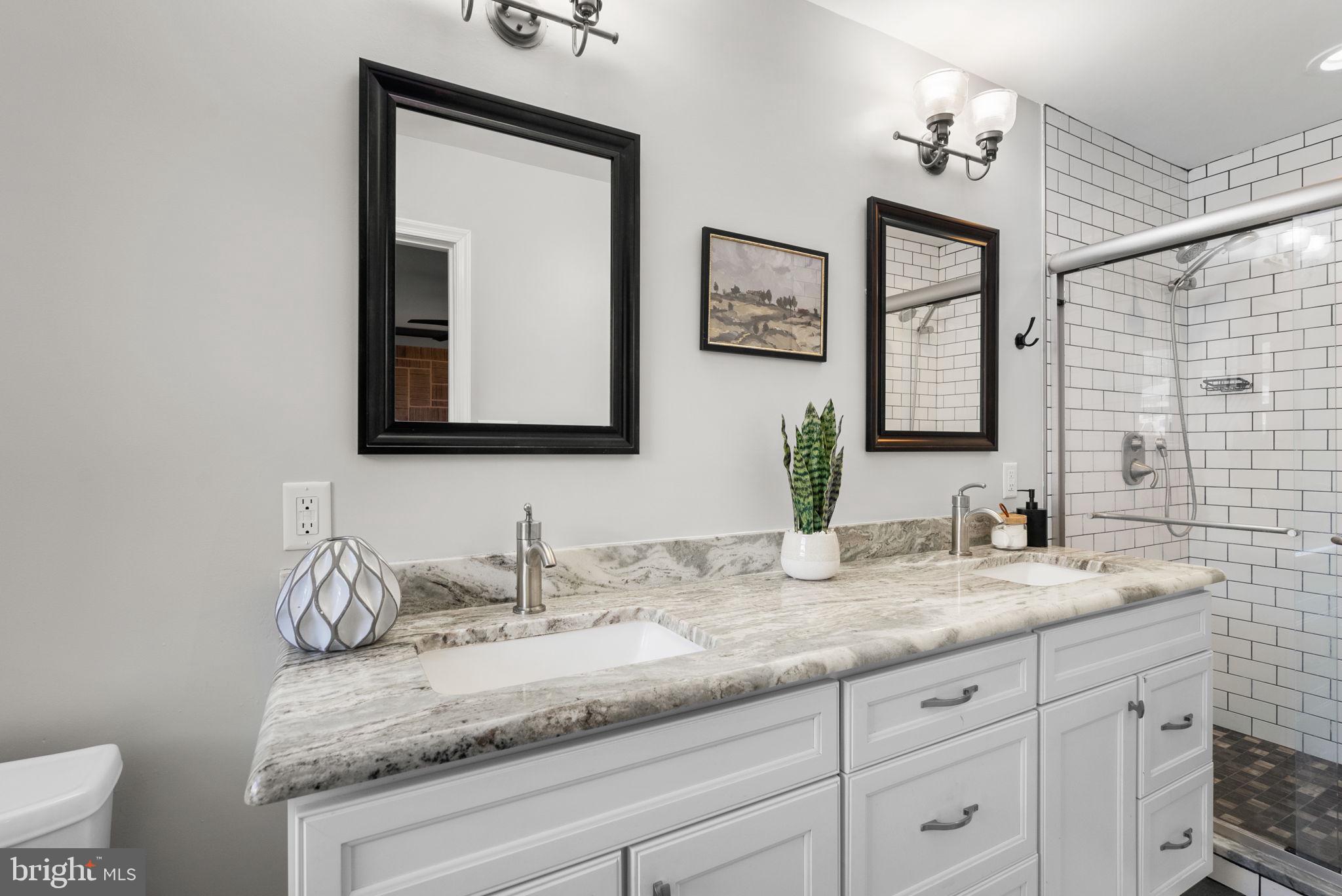 14530 Sturtevant Road Silver Spring, MD 20905 - Photo 20 of 47 a bathroom with double sink and a mirror