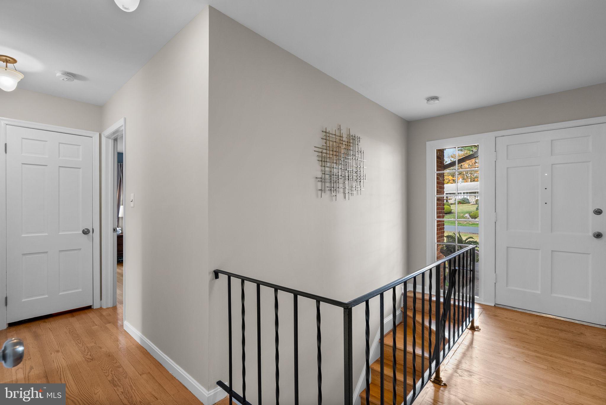 14530 Sturtevant Road Silver Spring, MD 20905 - Photo 2 of 47 a view of a hallway with wooden floor and windows