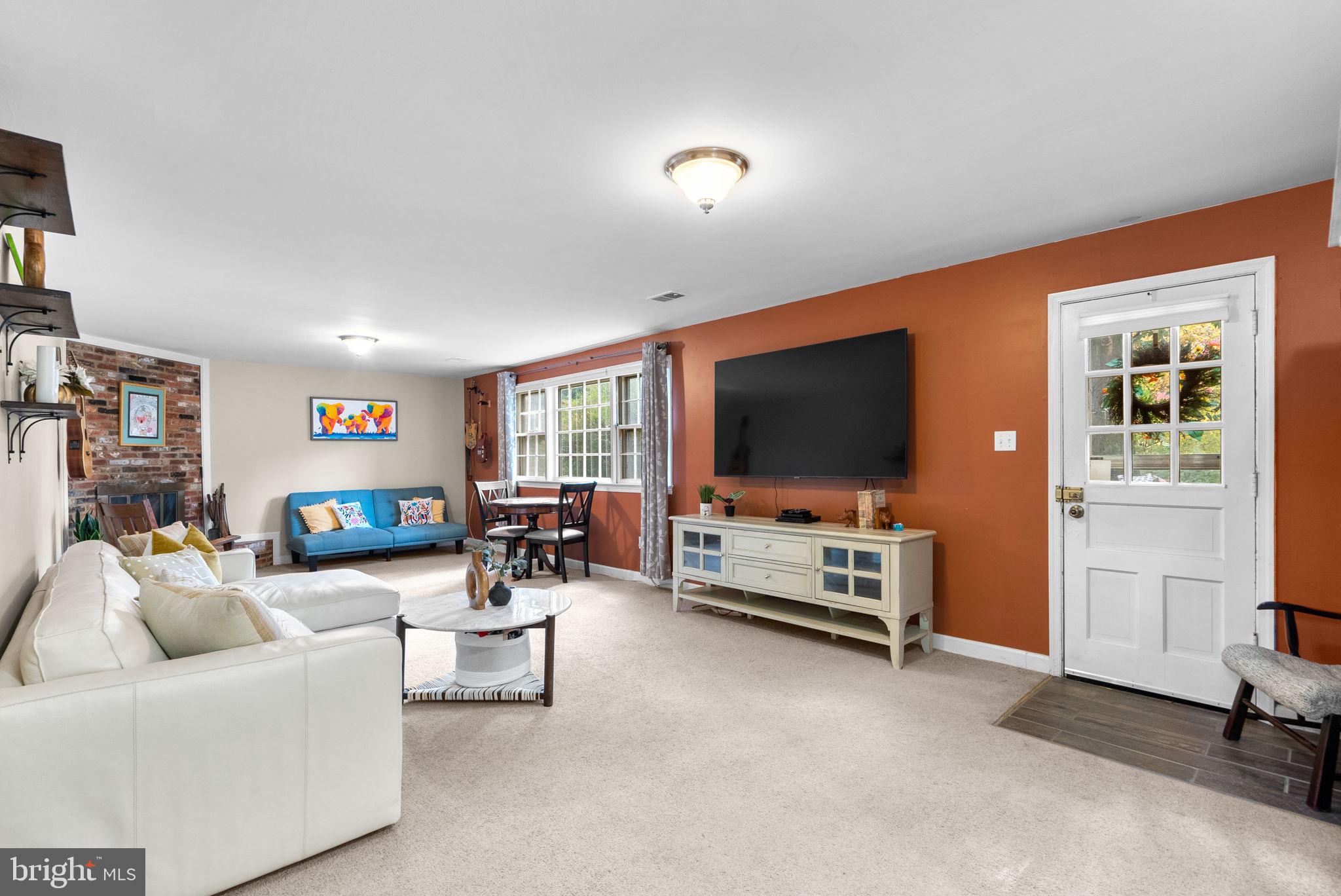 14530 Sturtevant Road Silver Spring, MD 20905 - Photo 29 of 47 a living room with furniture and a flat screen tv