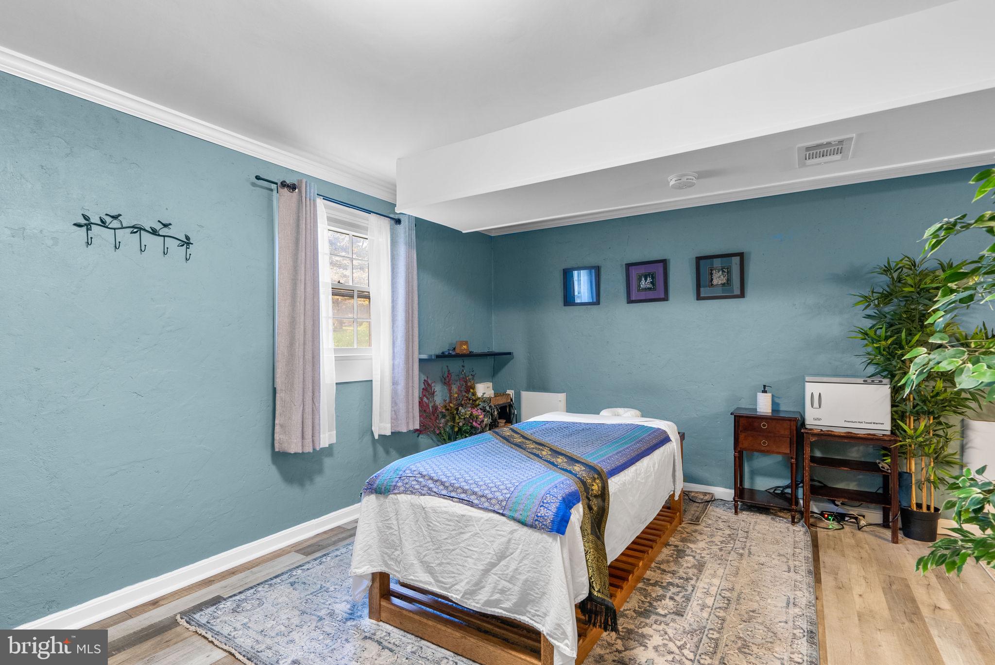 14530 Sturtevant Road Silver Spring, MD 20905 - Photo 34 of 47 a bedroom with a bed and a table in it