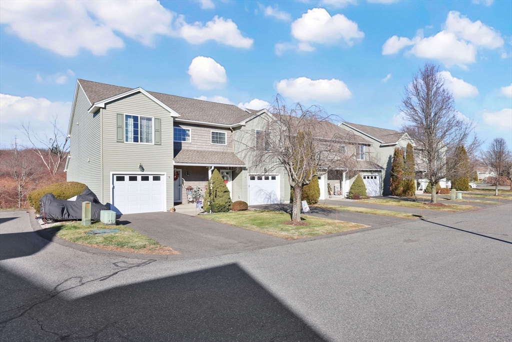 353 Fuller Street, Unit 8 Ludlow, MA 01056 - Photo 41 of 41 a front view of a house with a yard