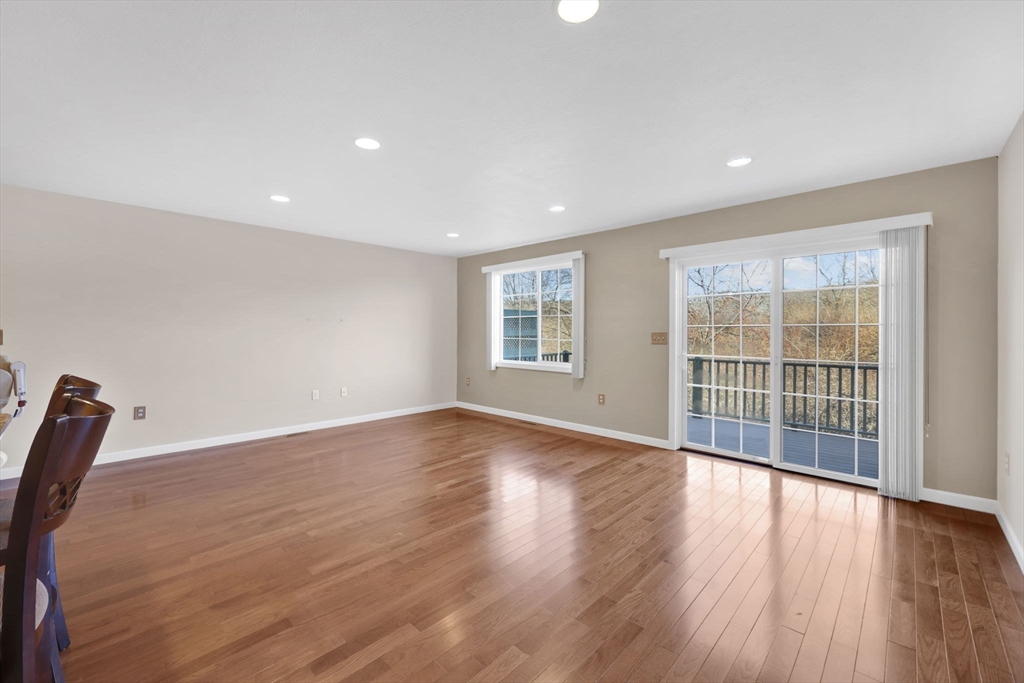 353 Fuller Street, Unit 8 Ludlow, MA 01056 - Photo 10 of 41 a view of an empty room with wooden floor and a window
