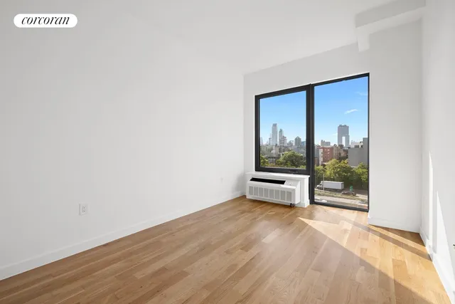 a view of a room with wooden floor and a window