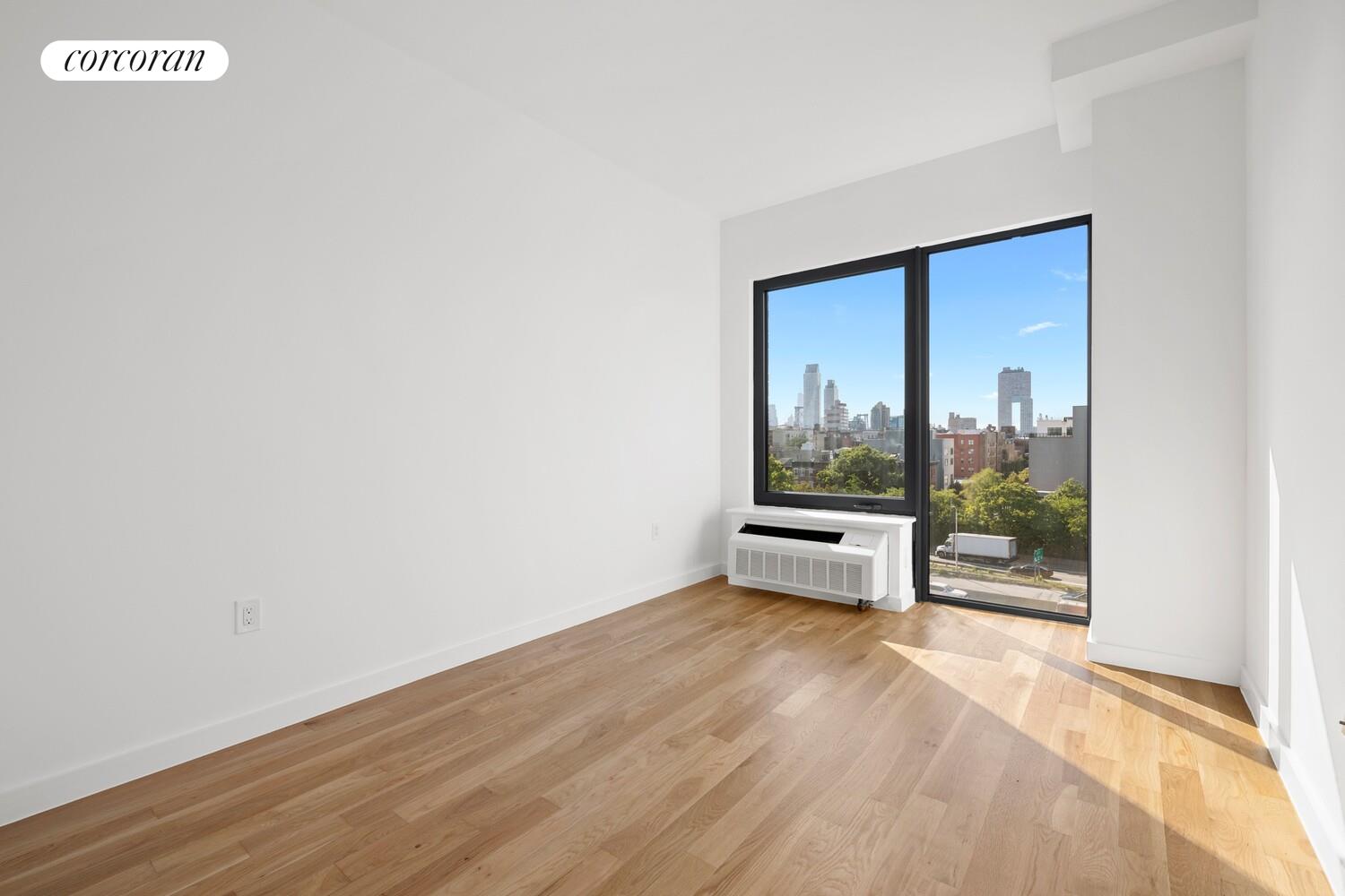 123 Hope Street, Unit 7R Brooklyn, NY 11211 - Photo 6 of 15 a view of a room with wooden floor and a window